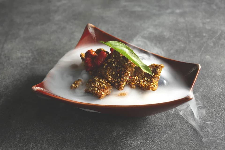 Crisp spiced mushrooms and squash on a sculpted plate