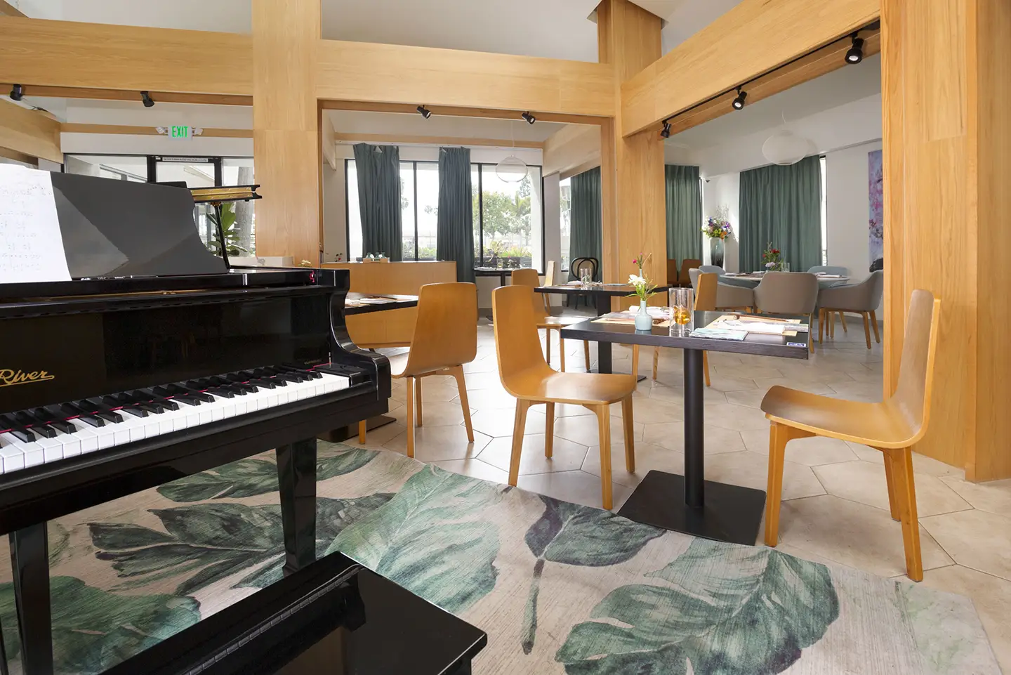 A spacious fine dining restaurant with a piano.